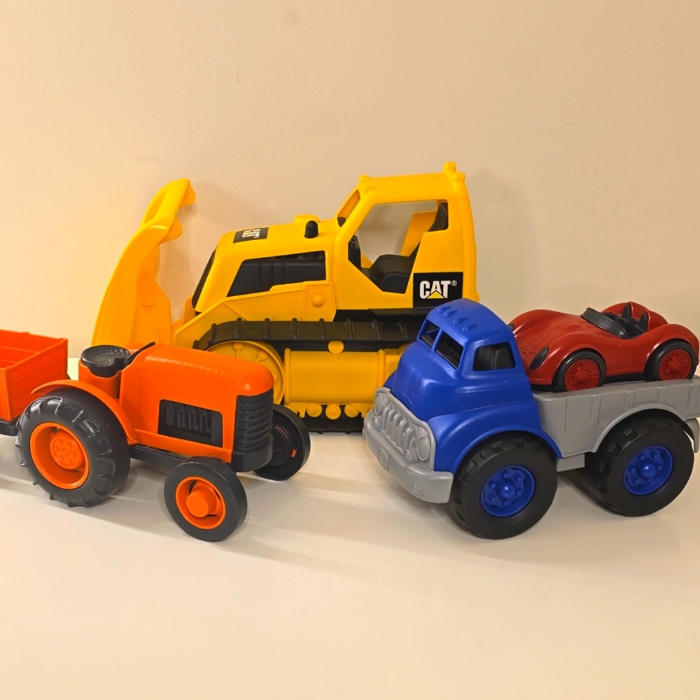 Green Toys Blue Flat Bed Truck, Red Race Car, Orange Tractor, and CAT bulldozer